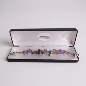 Purple Charm Bracelet with Silver Base and Decorative Elements